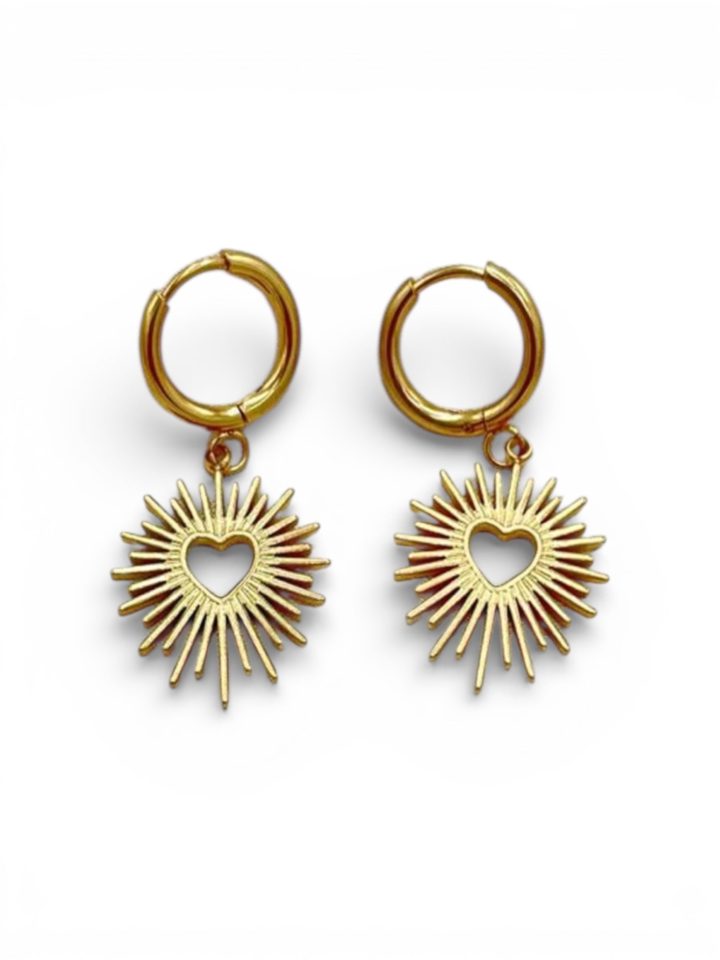 18K gold plated sacred heart sunburst charm huggie earrings
Platinum plated sacred heart water resistant earrings on white background
Close-up of sacred heart 