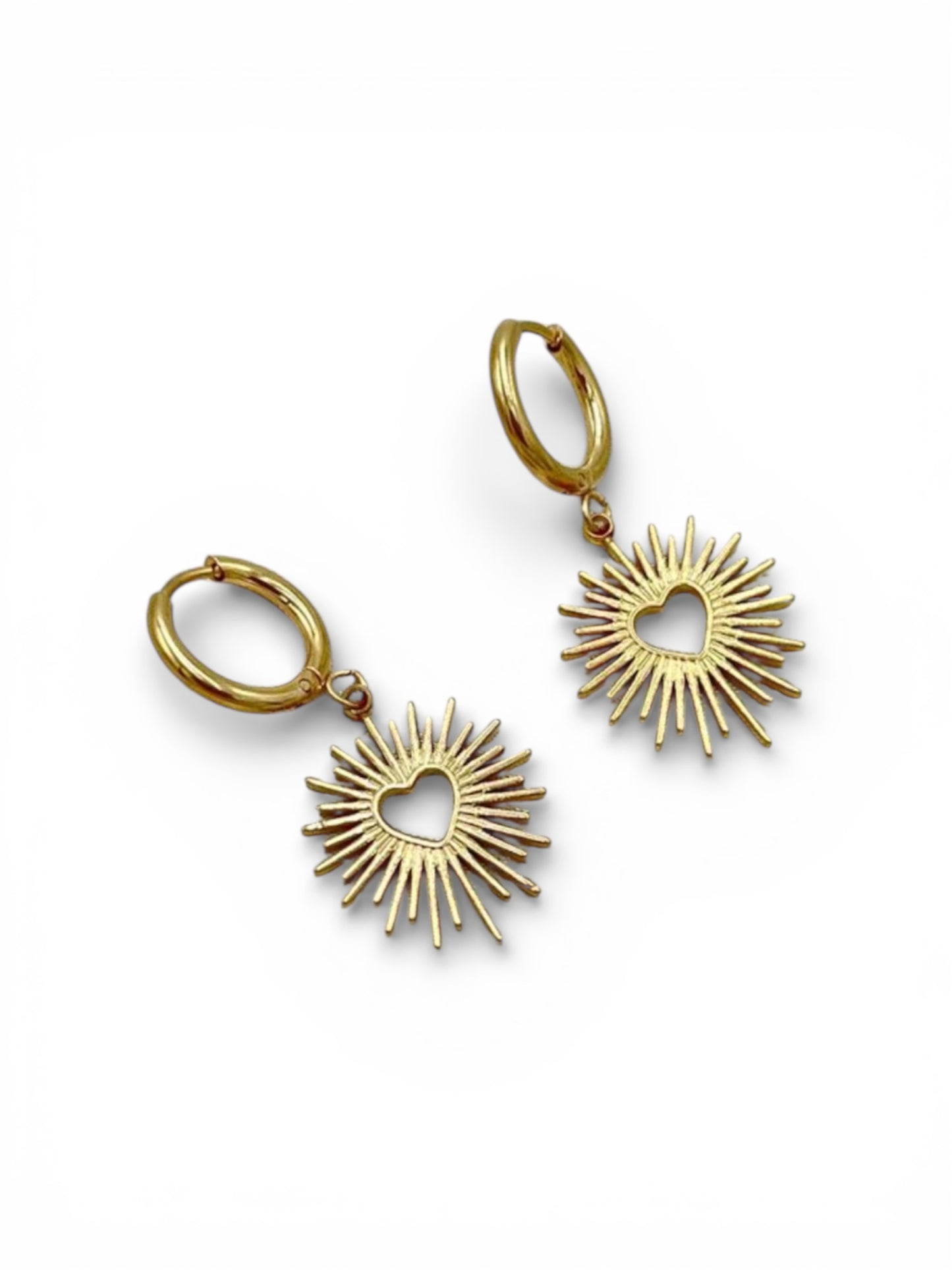 18K gold plated sacred heart sunburst charm huggie earrings
Platinum plated sacred heart water resistant earrings on white background
Close-up of sacred heart 